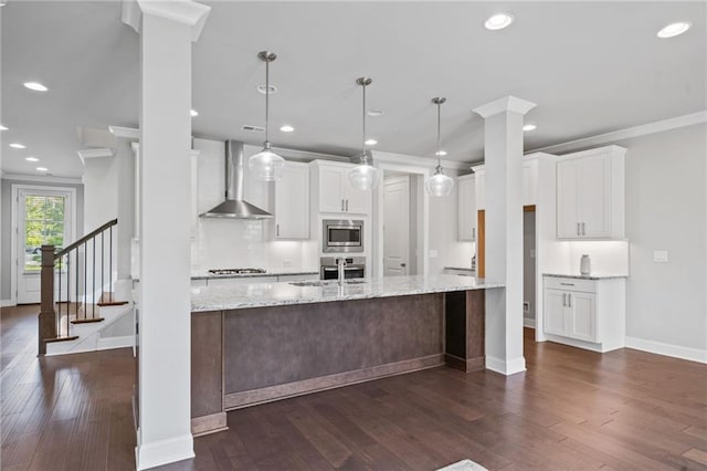 1858 Glenview Park Cir, Duluth, GA 30097 - kitchen featuring wall chimney exhaust hood, stainless steel appliances, crown molding, white cabinetry, and dark wood-style flooring