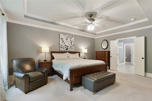bedroom featuring a tray ceiling, light carpet, crown molding, and baseboards