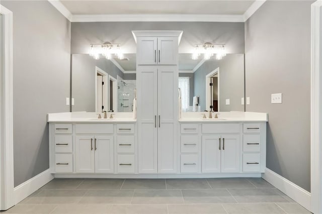 bathroom featuring crown molding, vanity, baseboards, tile patterned flooring, and a shower