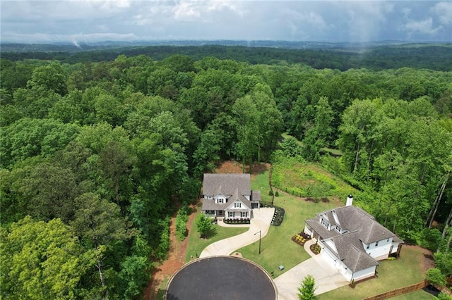view of subject property featuring a heavily wooded area