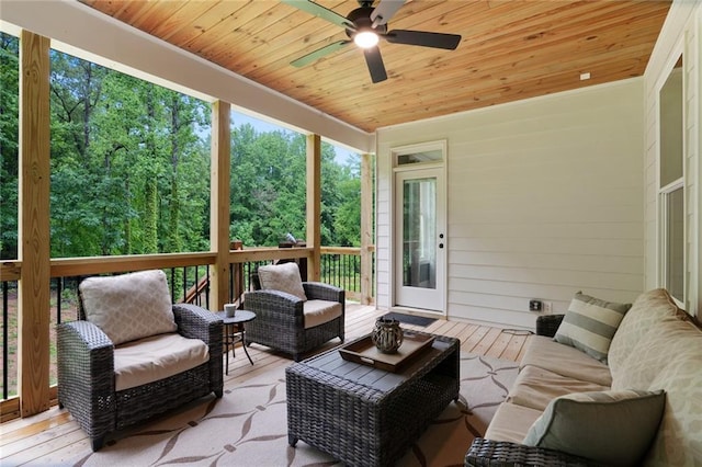 sunroom / solarium with an outdoor living space and a ceiling fan