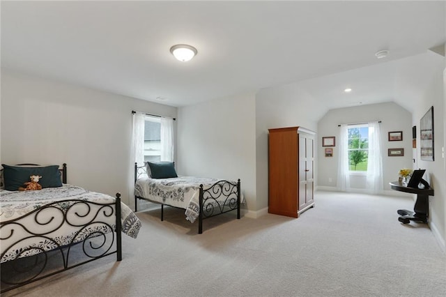 bedroom featuring carpet flooring, lofted ceiling, and baseboards
