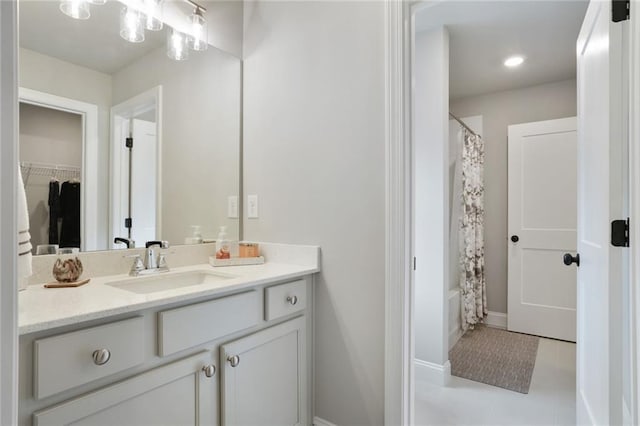 full bathroom featuring vanity, shower / bath combo, and baseboards