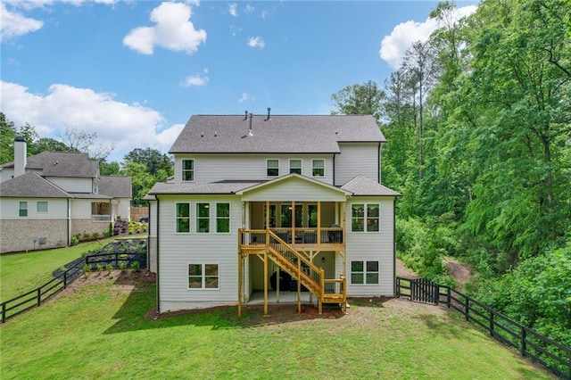 rear view of property with stairway and a sunroom
