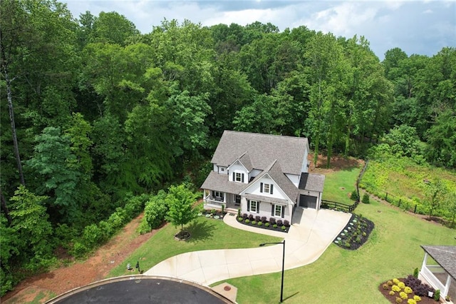 aerial view of property and surrounding area with a forest