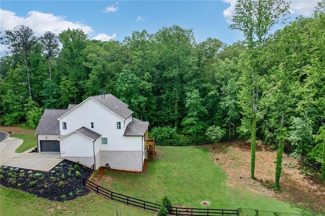 aerial view of property and surrounding area with a heavily wooded area