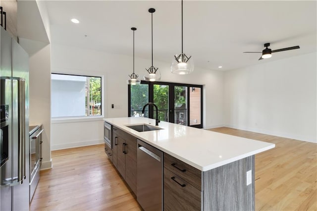 367 Parkway Dr NE Unit 9, Atlanta, GA 30312 - kitchen with a sink, appliances with stainless steel finishes, light wood-style floors, baseboards, and light countertops