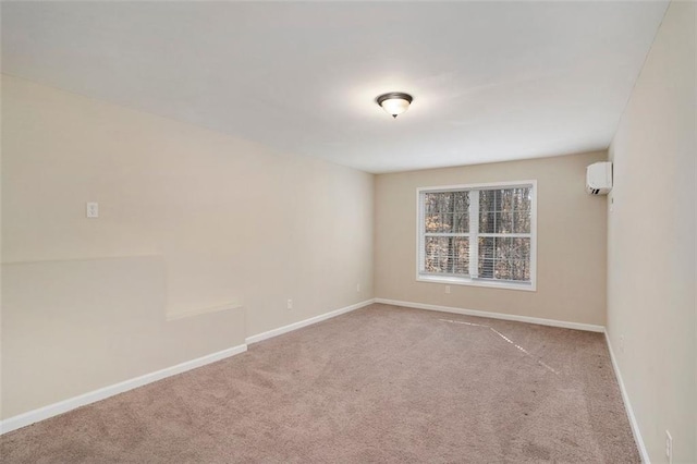 carpeted empty room featuring a wall unit AC and baseboards