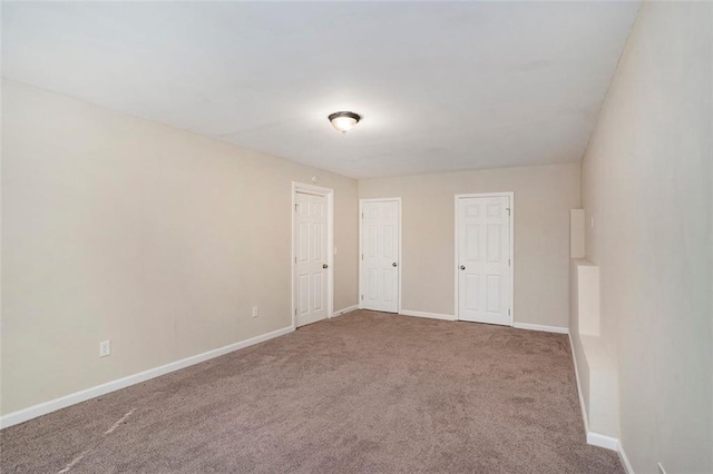 unfurnished room featuring baseboards and carpet flooring