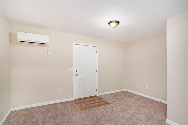 carpeted spare room with baseboards and a wall mounted AC