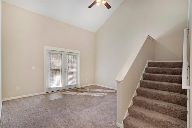 interior space with high vaulted ceiling, baseboards, stairs, french doors, and carpet