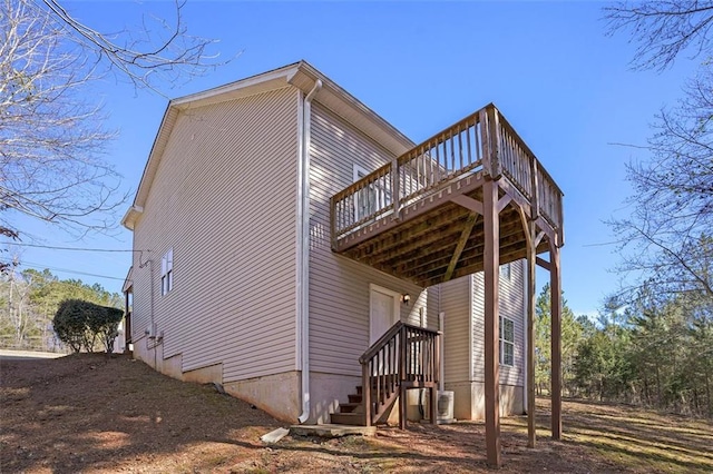 view of home's exterior featuring a wooden deck and central AC unit