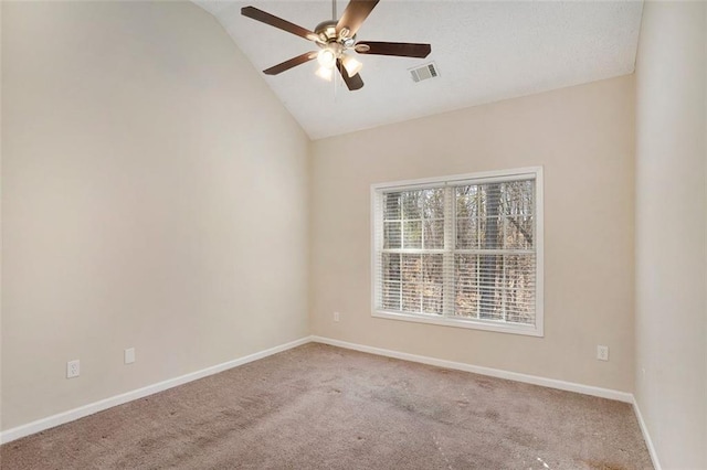 unfurnished room featuring carpet floors, visible vents, a ceiling fan, vaulted ceiling, and baseboards