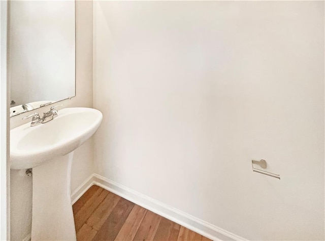 bathroom featuring wood-type flooring and sink