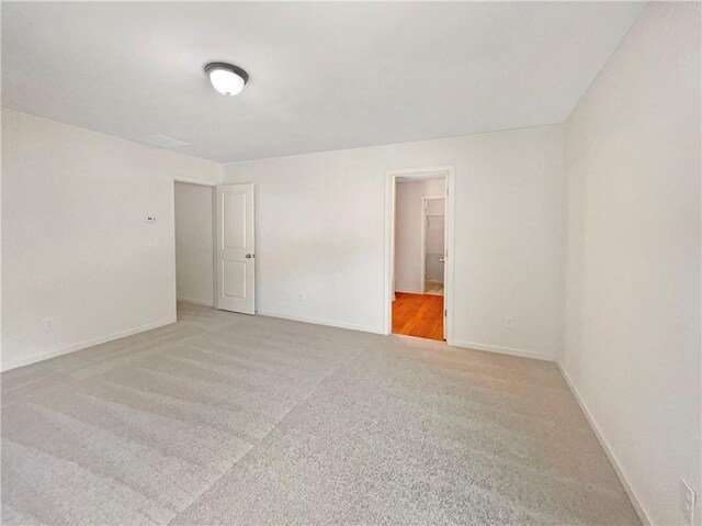 spare room featuring light colored carpet