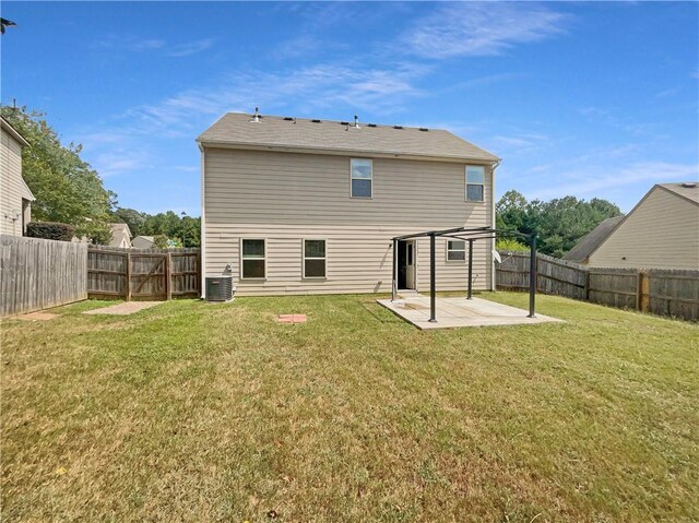 rear view of house with a yard, a patio, and central AC