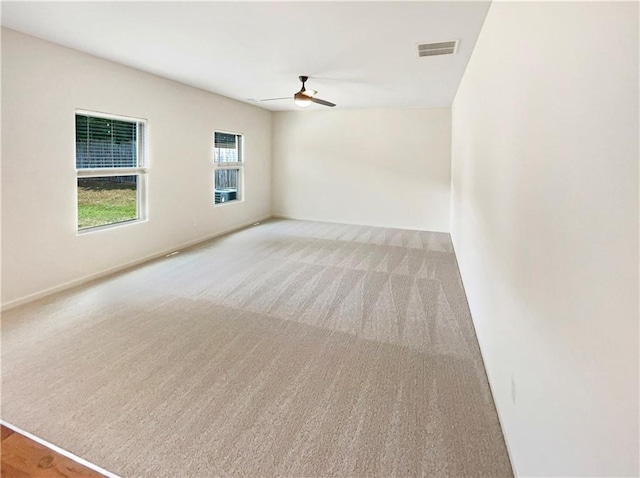 empty room with light carpet and ceiling fan