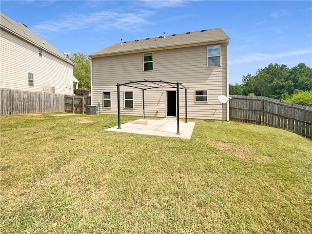 rear view of property featuring a pergola, central AC unit, a patio area, and a lawn