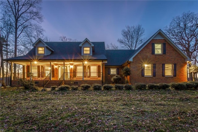 view of front facade with crawl space, a porch, and brick siding