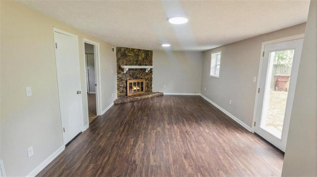 1328 Hoy Taylor Dr, Norcross, GA 30093 - unfurnished living room with wood finished floors, baseboards, and a stone fireplace