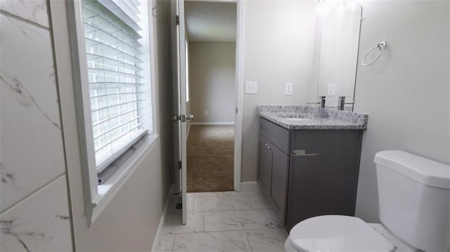1328 Hoy Taylor Dr, Norcross, GA 30093 - bathroom with marble look tiles, toilet, vanity, and baseboards