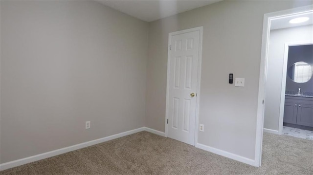 1328 Hoy Taylor Dr, Norcross, GA 30093 - unfurnished bedroom featuring light colored carpet, baseboards, a sink, and connected bathroom
