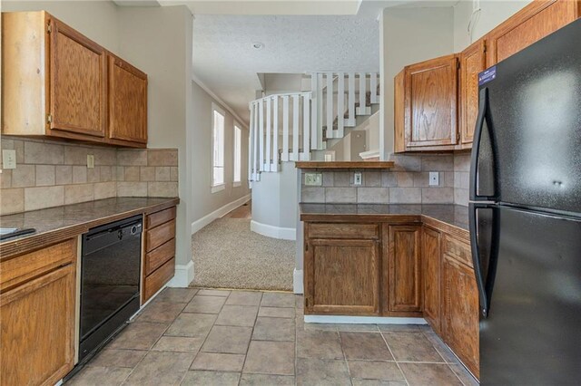 1124 Lawton Pl SW, Atlanta, GA 30310 - kitchen with light colored carpet, baseboards, backsplash, black appliances, and brown cabinets