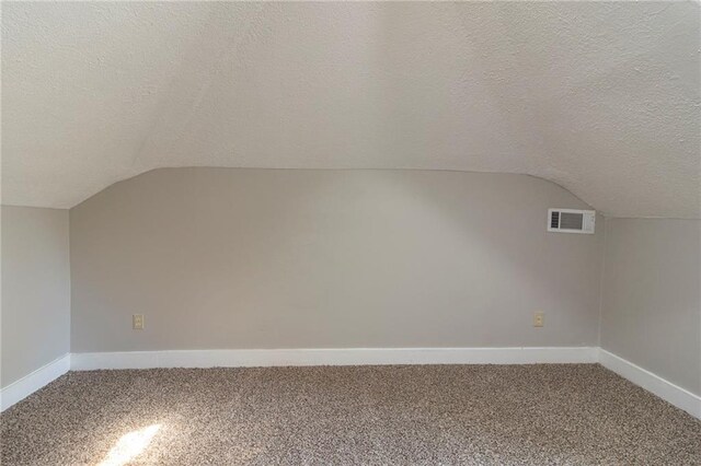1124 Lawton Pl SW, Atlanta, GA 30310 - additional living space featuring a textured ceiling, visible vents, baseboards, carpet floors, and vaulted ceiling