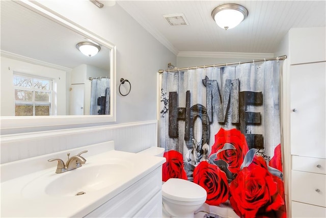 bathroom featuring toilet, vanity, ornamental molding, and a shower with shower curtain