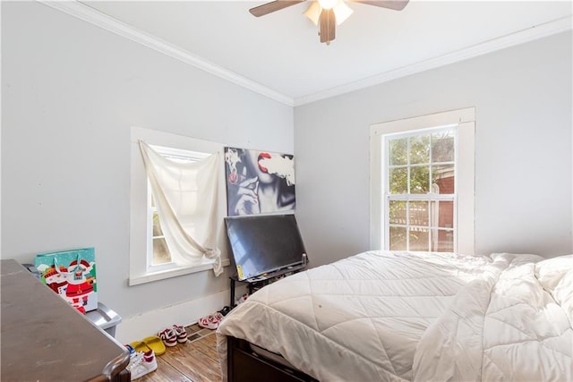 bedroom with ceiling fan, hardwood / wood-style floors, and ornamental molding