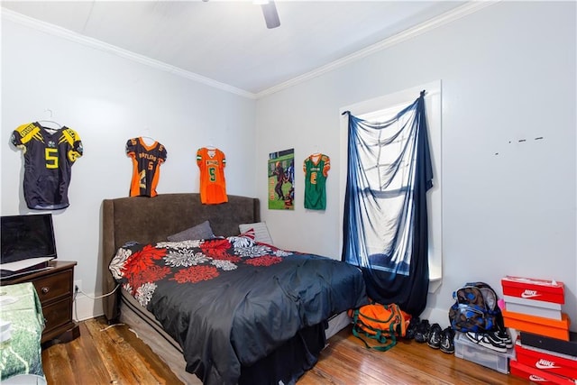 bedroom featuring ceiling fan, crown molding, and hardwood / wood-style flooring