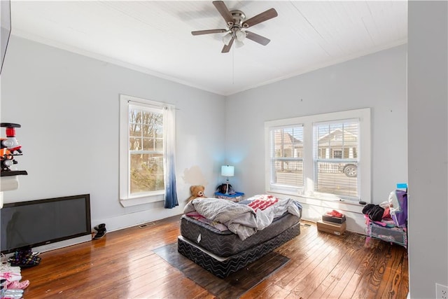 bedroom with ceiling fan, hardwood / wood-style floors, and ornamental molding