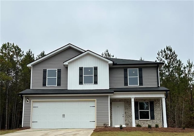 view of front facade with an attached garage, covered porch, and driveway