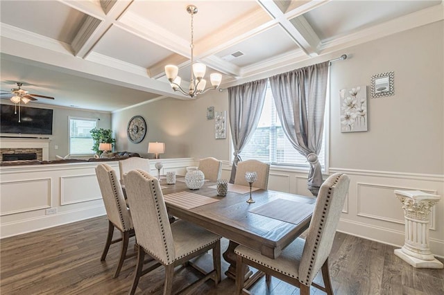 dining room with dark hardwood / wood-style flooring, ceiling fan with notable chandelier, and coffered ceiling