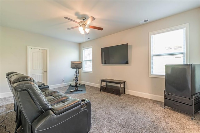 carpeted living room featuring ceiling fan