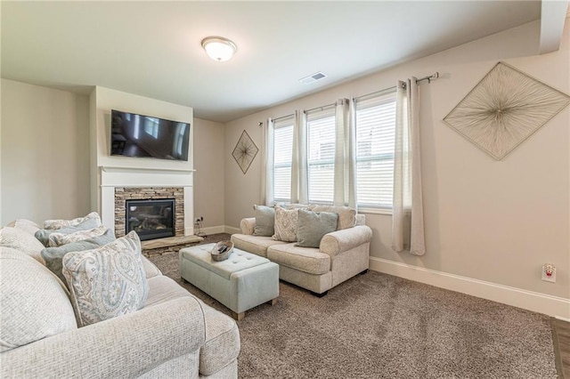 living room with dark wood-type flooring and a stone fireplace