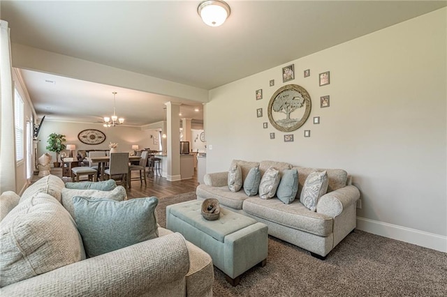 carpeted living room with a chandelier