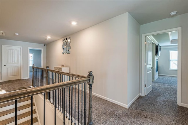 hallway featuring dark colored carpet