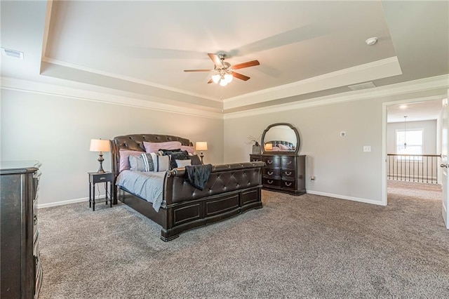 bedroom featuring crown molding, dark colored carpet, ceiling fan, and a tray ceiling