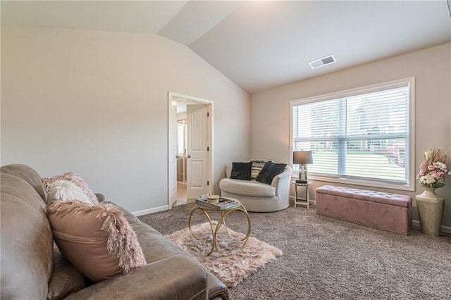 carpeted living room with lofted ceiling