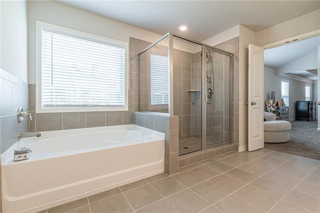 bathroom with tile flooring and separate shower and tub