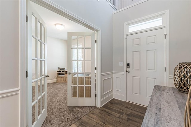 entrance foyer featuring dark colored carpet and french doors