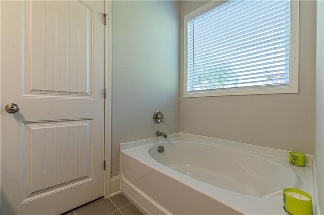 bathroom featuring a bathtub and tile flooring