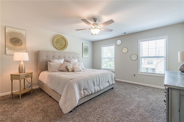 bedroom with ceiling fan and dark colored carpet