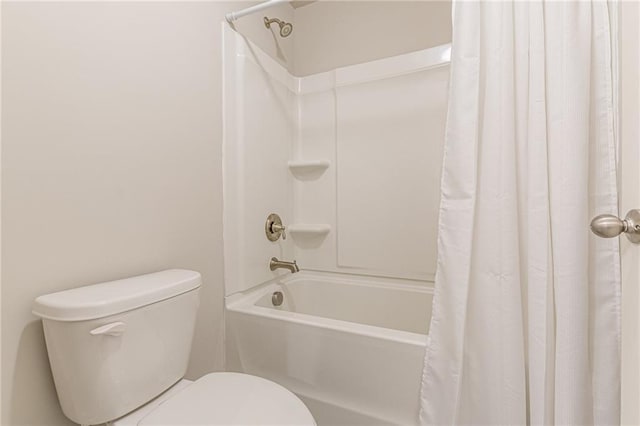 bathroom featuring toilet and shower / bath combination with curtain