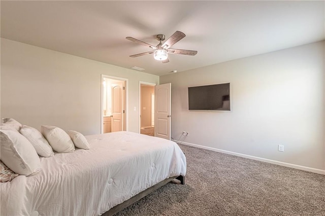 bedroom with ceiling fan, connected bathroom, and dark colored carpet