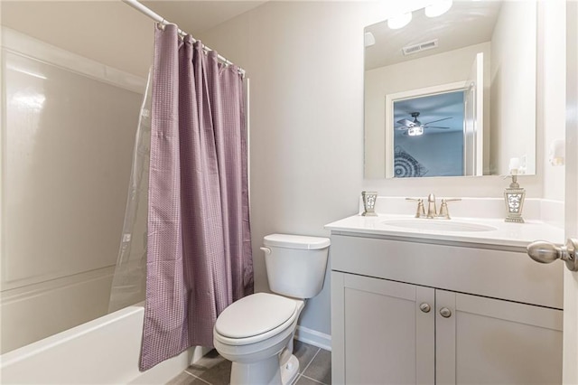 full bathroom featuring tile floors, ceiling fan, toilet, vanity with extensive cabinet space, and shower / bath combo with shower curtain