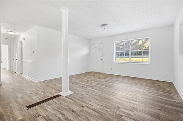 interior space featuring a textured ceiling and light hardwood / wood-style floors