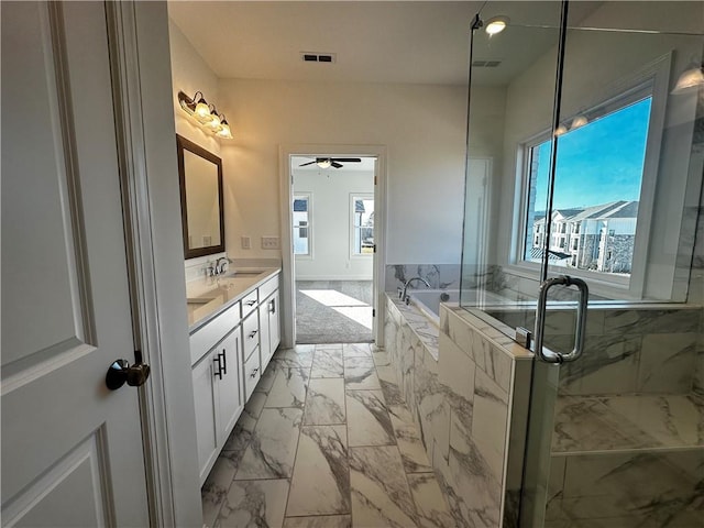 508 Healy Dr Unit 70, Cumming, GA 30040 - full bathroom featuring marble look tile flooring, plenty of natural light, a ceiling fan, and a bath