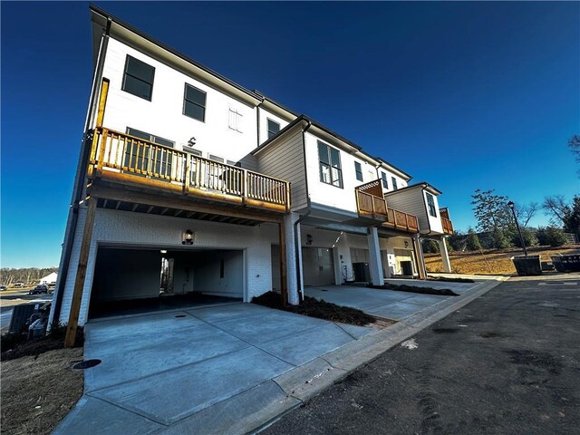 508 Healy Dr Unit 70, Cumming, GA 30040 - rear view of property with a garage, a balcony, and concrete driveway